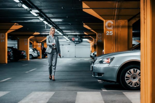 Successful,Businesswoman,Walking,To,Her,Car,In,Underground,Car,Parking.