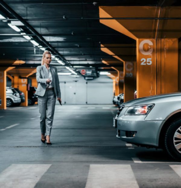 Successful,Businesswoman,Walking,To,Her,Car,In,Underground,Car,Parking.