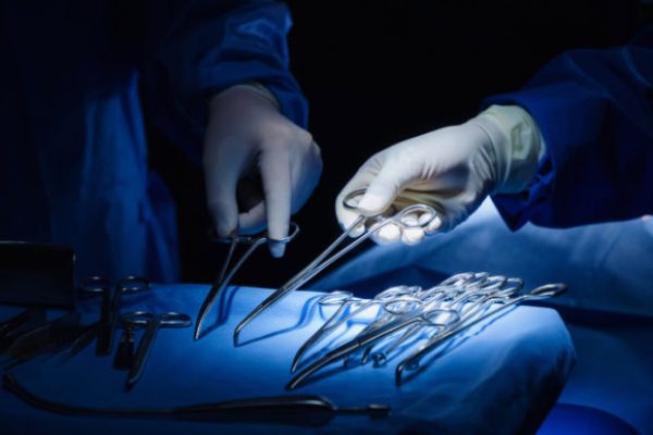 Close,Up,Surgeons,Hand,Taking,Scissors,,Forceps,And,Surgical,Instruments
